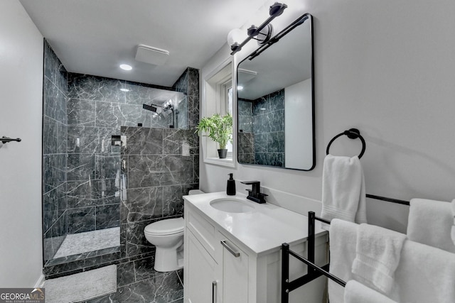 full bath with marble finish floor, toilet, vanity, and a walk in shower