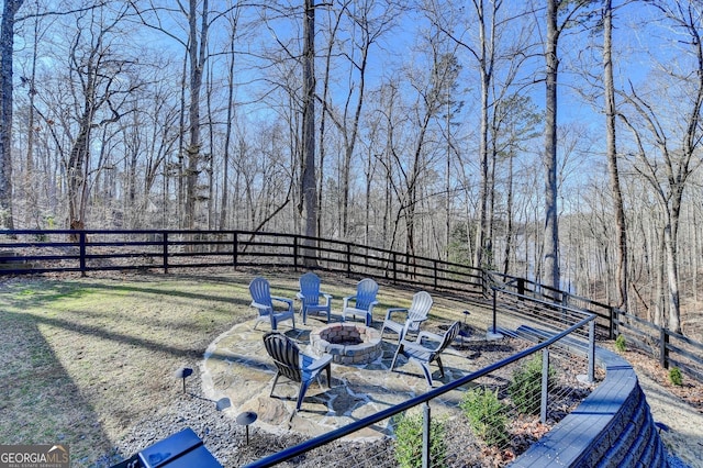 view of yard with a fire pit and a fenced backyard