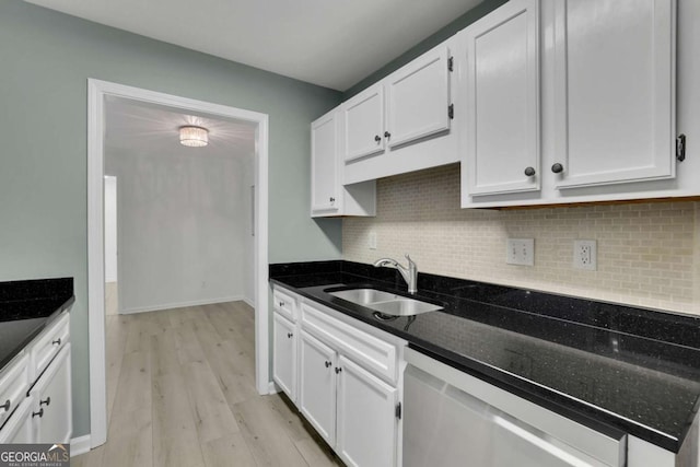 kitchen with white cabinetry, sink, tasteful backsplash, dishwasher, and dark stone countertops