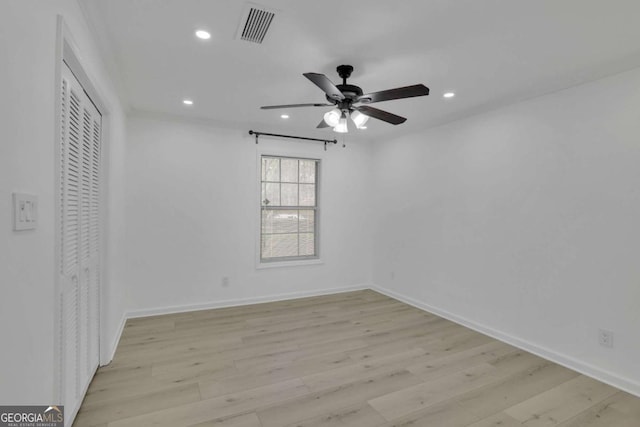 unfurnished bedroom with ceiling fan, light hardwood / wood-style flooring, and a closet