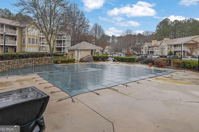 view of pool with a patio area and a grill