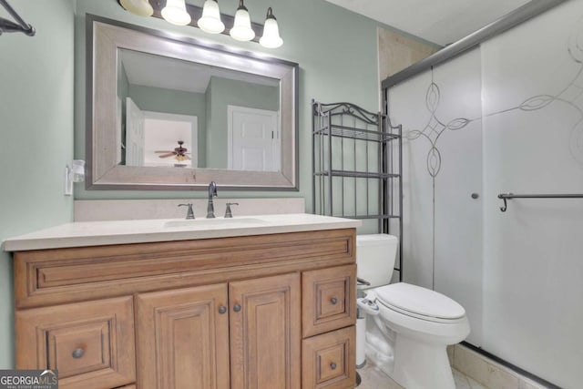 bathroom featuring toilet, vanity, and walk in shower