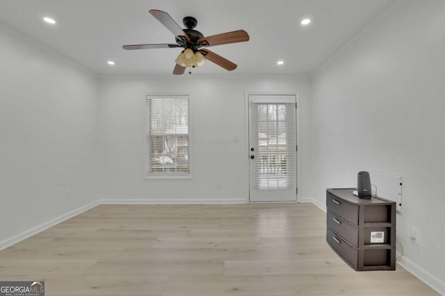 foyer with ceiling fan and light wood-type flooring