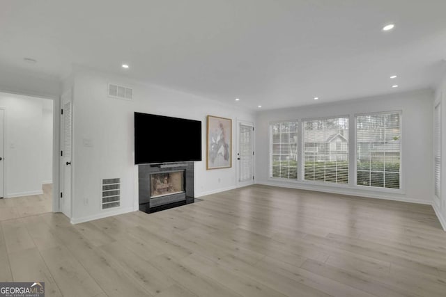 unfurnished living room featuring light hardwood / wood-style floors