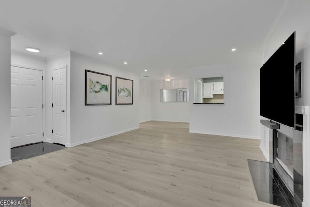 unfurnished living room featuring light wood-type flooring