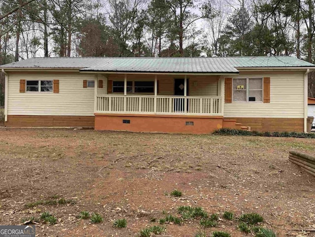 ranch-style home featuring covered porch and metal roof