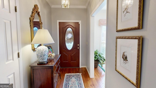 entrance foyer featuring hardwood / wood-style floors and crown molding