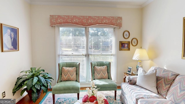 living room with hardwood / wood-style flooring, plenty of natural light, and ornamental molding