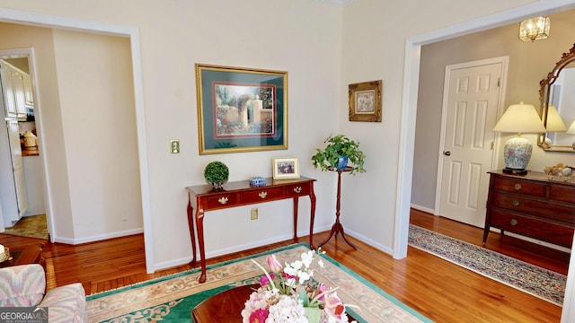 living area featuring an inviting chandelier and wood-type flooring