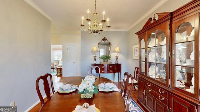 dining area with hardwood / wood-style flooring, an inviting chandelier, and ornamental molding