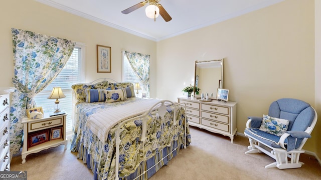 carpeted bedroom with ceiling fan and ornamental molding