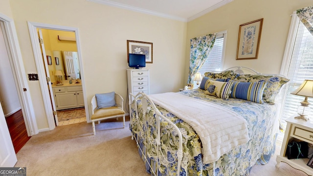 carpeted bedroom with ensuite bath and crown molding