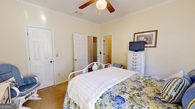 carpeted bedroom with ceiling fan and ornamental molding