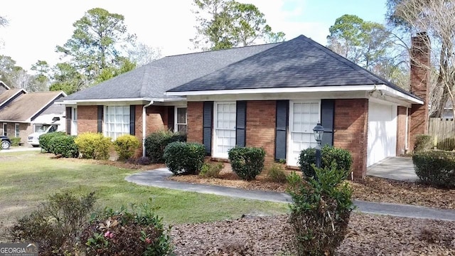 single story home featuring a garage and a front lawn