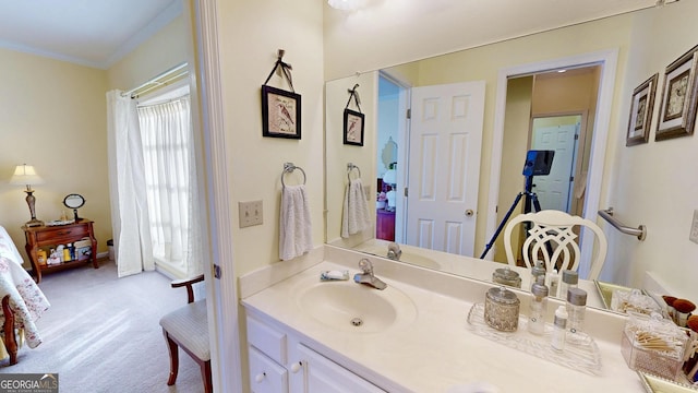 bathroom with ornamental molding and vanity