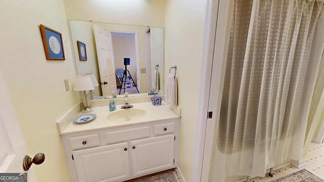 bathroom with curtained shower and vanity