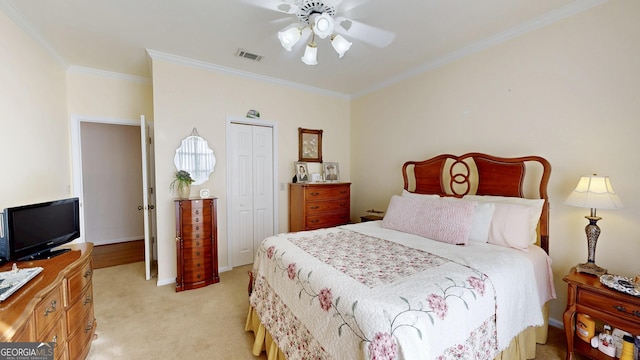 carpeted bedroom featuring a closet, ceiling fan, and ornamental molding