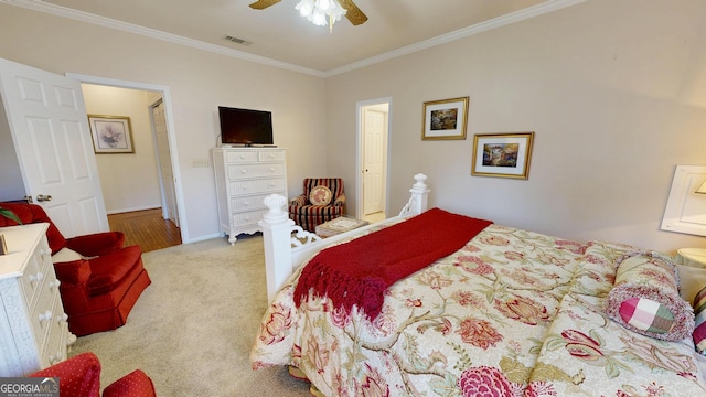 carpeted bedroom featuring ceiling fan and ornamental molding