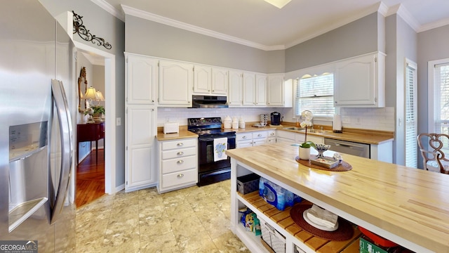 kitchen with stainless steel appliances, sink, ornamental molding, wood counters, and white cabinets