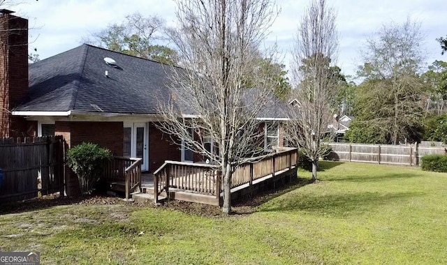 back of house featuring a yard and a wooden deck