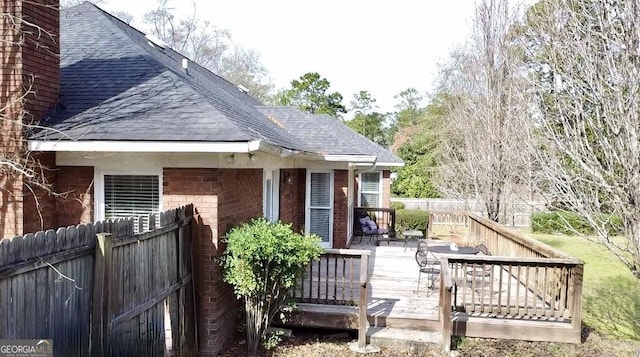 back of property featuring a deck