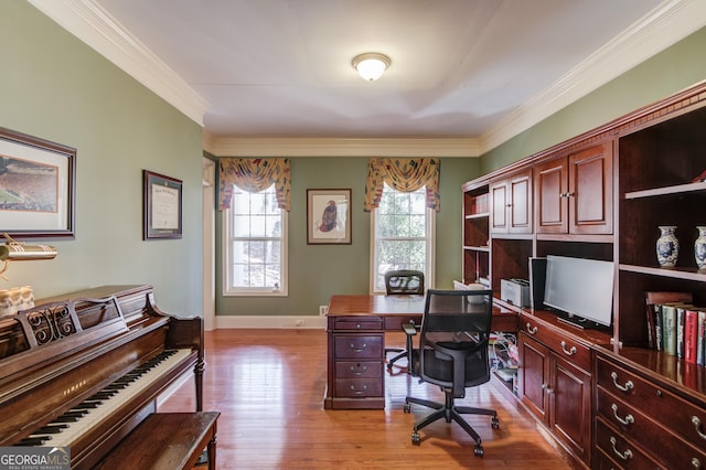 home office featuring crown molding, baseboards, and light wood-style floors