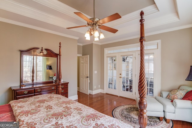 bedroom with wood finished floors, access to outside, french doors, a raised ceiling, and crown molding