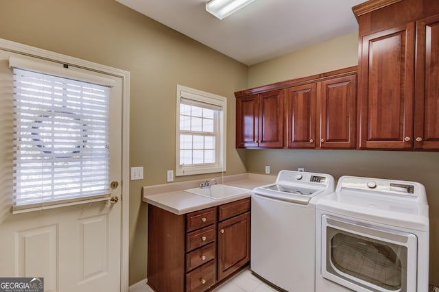 clothes washing area featuring independent washer and dryer, cabinet space, and a sink