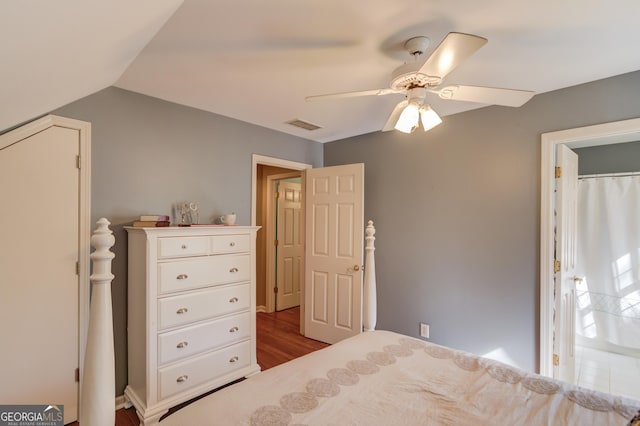 unfurnished bedroom featuring a ceiling fan, visible vents, vaulted ceiling, and light wood finished floors