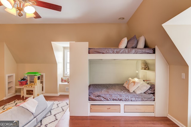 bedroom featuring lofted ceiling, ceiling fan, and wood finished floors