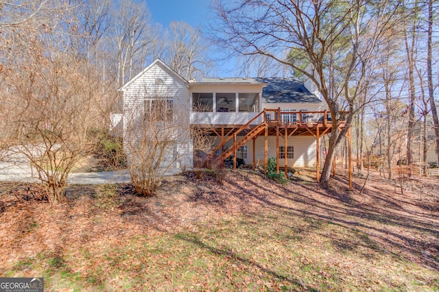 view of front facade with a sunroom, stairs, and a deck