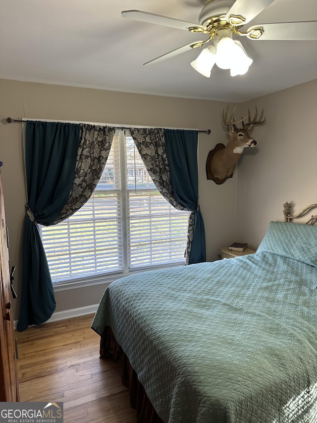 bedroom featuring hardwood / wood-style flooring and ceiling fan