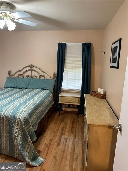 bedroom featuring light wood-type flooring and ceiling fan