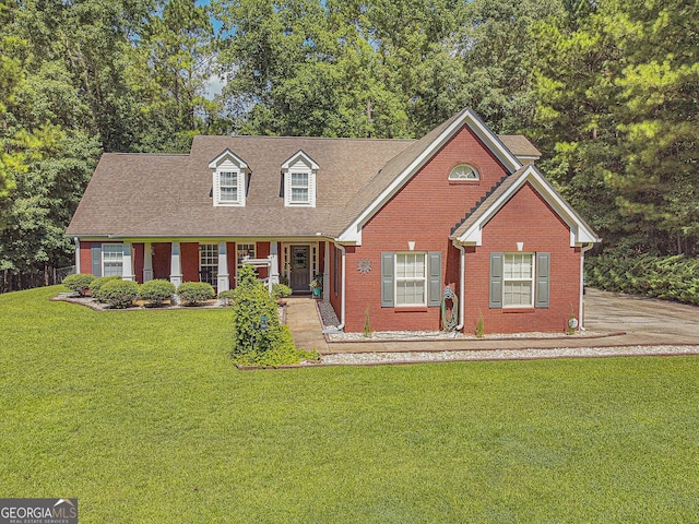 view of front of home with brick siding and a front lawn