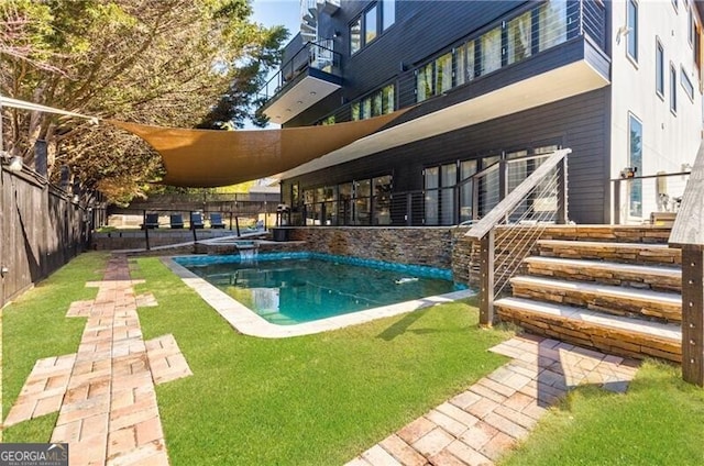 view of swimming pool with a patio area, a lawn, a fenced backyard, and a pool with connected hot tub