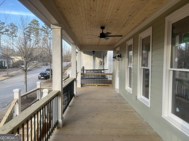 wooden deck with ceiling fan and a porch