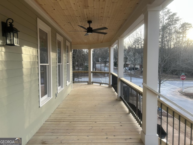 wooden terrace featuring ceiling fan and covered porch