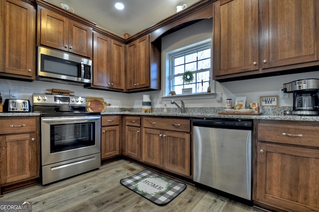 185 Sundown Trl, Ellijay, GA 30540 - kitchen featuring stainless steel appliances, light wood-style flooring, and stone countertops
