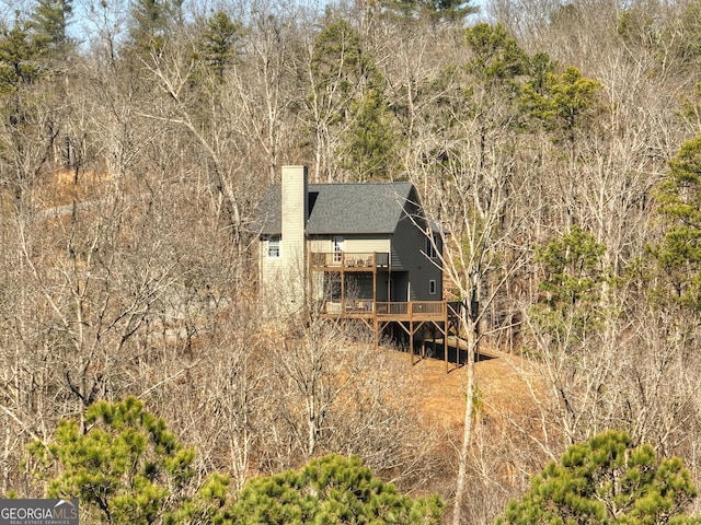 185 Sundown Trl, Ellijay, GA 30540 - back of house featuring a chimney, a wooden deck, and roof with shingles
