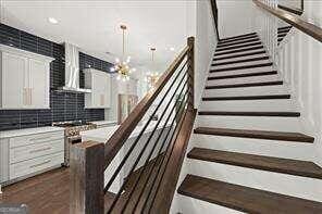 stairway with a chandelier