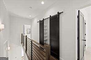 hallway featuring a barn door