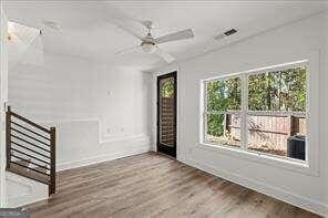 unfurnished room with hardwood / wood-style floors and ceiling fan