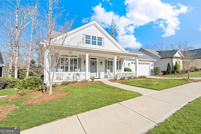 view of front of home with a garage, a front yard, and a porch