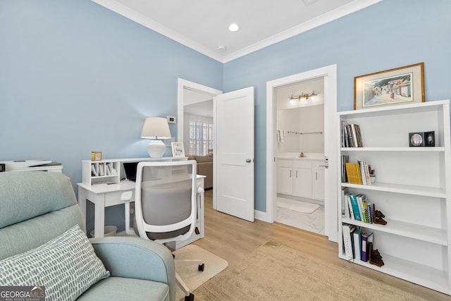 office space with ornamental molding and light hardwood / wood-style flooring