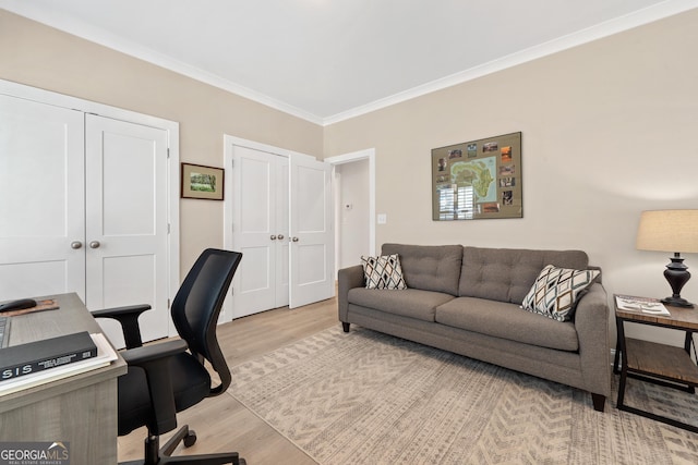 office with light wood-type flooring and crown molding