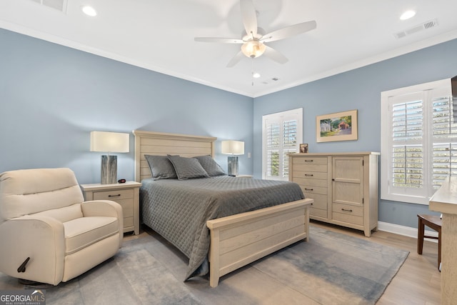 bedroom with ceiling fan, light wood-type flooring, and crown molding