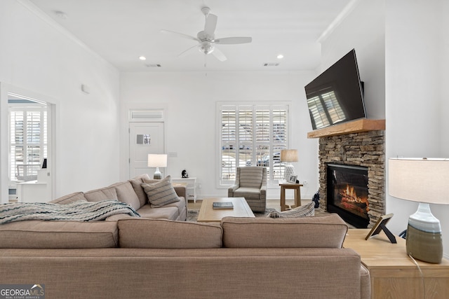 living room with a fireplace, ceiling fan, a healthy amount of sunlight, and wood-type flooring