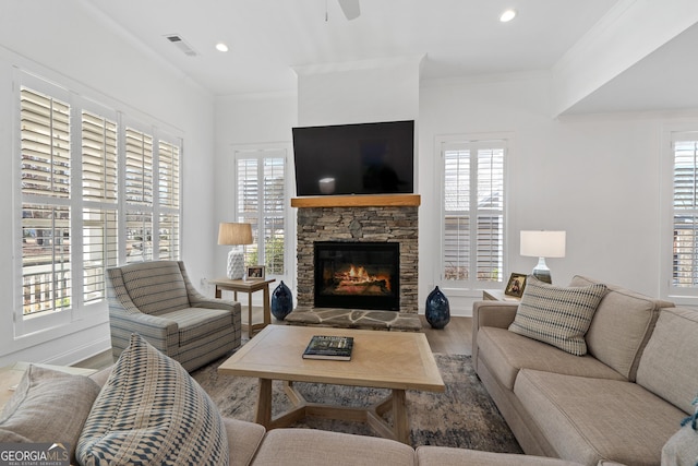 living room featuring ornamental molding, hardwood / wood-style floors, and a healthy amount of sunlight