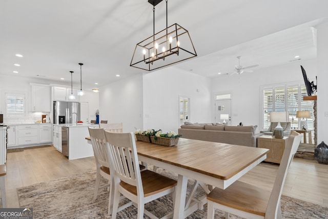 dining space with ceiling fan and light hardwood / wood-style floors