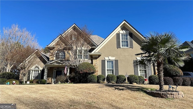 view of front of home featuring a front yard and stucco siding